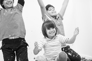 Image showing kids  blowing confetti