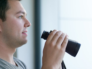 Image showing man looking with binoculars