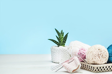 Image showing The balls of wool on white wooden background