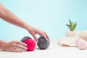 Image showing The balls of wool on white wooden background