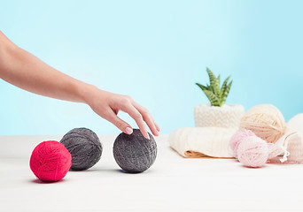 Image showing The balls of wool on white wooden background