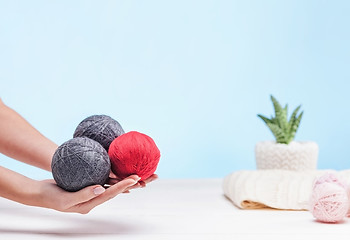 Image showing The balls of wool on white wooden background