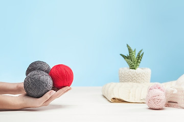 Image showing The balls of wool on white wooden background