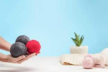 Image showing The balls of wool on white wooden background