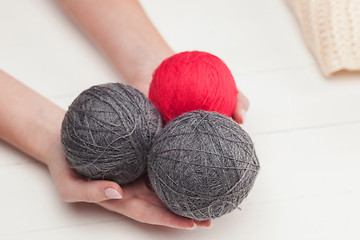 Image showing The balls of wool on white wooden background