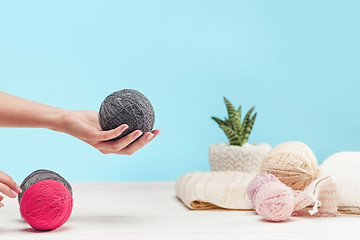 Image showing The balls of wool on white wooden background