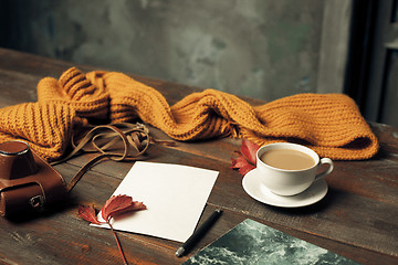 Image showing Opened craft paper envelope , autumn leaves and coffee on wooden table