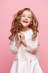 Image showing The beautiful little girl in dress standing and posing over white background