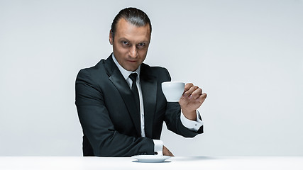 Image showing The attractive man in black suit on white background