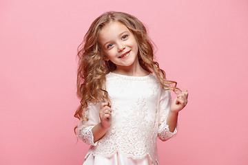 Image showing The beautiful little girl in dress standing and posing over white background