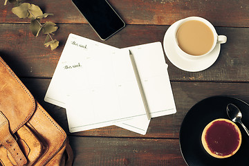 Image showing Opened craft paper envelope , autumn leaves and coffee on wooden table