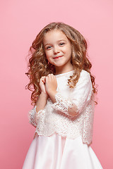 Image showing The beautiful little girl in dress standing and posing over white background