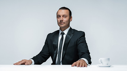 Image showing The attractive man in black suit on white background