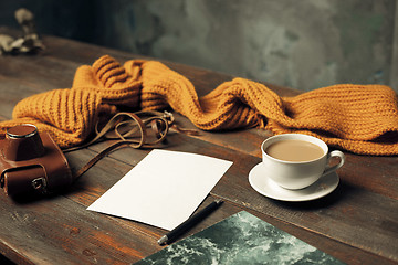 Image showing Opened craft paper envelope , autumn leaves and coffee on wooden table