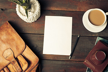 Image showing Opened craft paper envelope , autumn leaves and coffee on wooden table