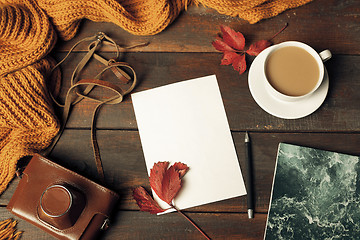 Image showing Opened craft paper envelope , autumn leaves and coffee on wooden table