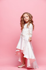 Image showing Full length of beautiful little girl in dress standing and posing over white background