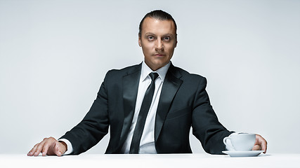 Image showing The attractive man in black suit on white background
