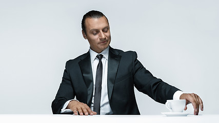 Image showing The attractive man in black suit on white background