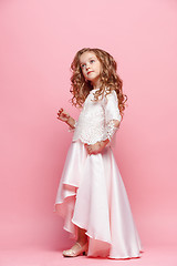 Image showing Full length of beautiful little girl in dress standing and posing over white background