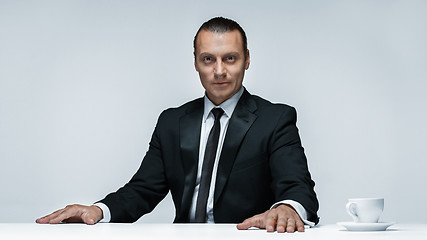 Image showing The attractive man in black suit on white background