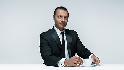 Image showing The attractive man in black suit on white background