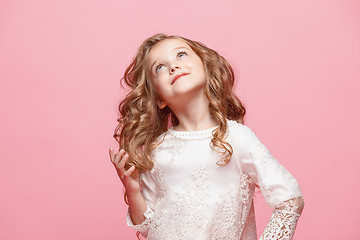 Image showing The beautiful little girl in dress standing and posing over white background
