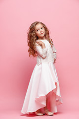 Image showing Full length of beautiful little girl in dress standing and posing over white background