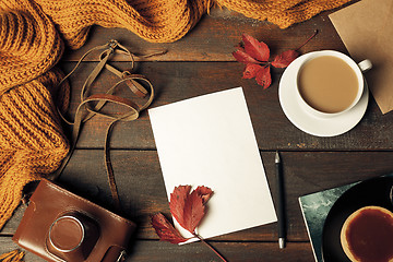 Image showing Opened craft paper envelope , autumn leaves and coffee on wooden table