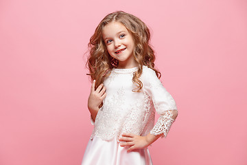 Image showing The beautiful little girl in dress standing and posing over white background