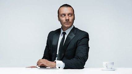 Image showing The attractive man in black suit on white background