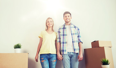 Image showing smiling couple with big boxes moving to new home