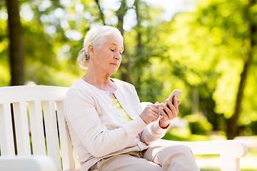 Image showing senior woman with smartphone at summer park