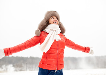 Image showing happy woman in winter fur hat outdoors