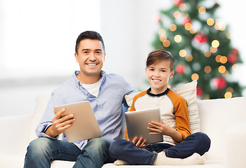 Image showing happy father and son with tablet pc at christmas