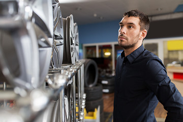 Image showing male customer choosing wheel rims at car service