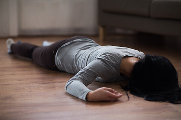 Image showing dead woman body lying on floor at crime scene