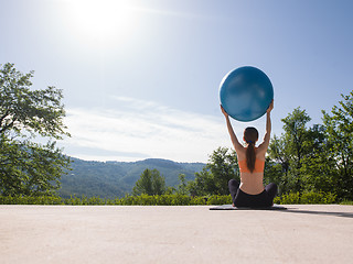 Image showing woman doing exercise with pilates ball