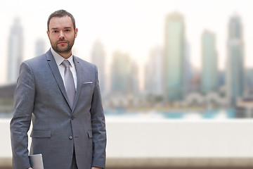 Image showing Young businessman in front of the big city