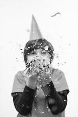 Image showing kid blowing confetti