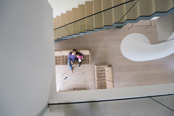 Image showing mother and her cute little daughter are using a tablet top view