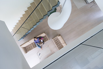 Image showing mother and her cute little daughter are using a tablet top view