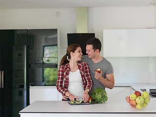 Image showing Young handsome couple in the kitchen