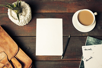 Image showing Opened craft paper envelope , autumn leaves and coffee on wooden table