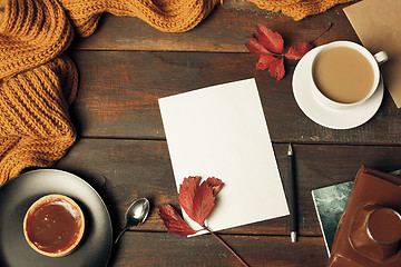 Image showing Opened craft paper envelope , autumn leaves and coffee on wooden table
