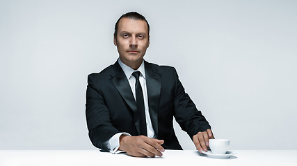 Image showing The attractive man in black suit on white background