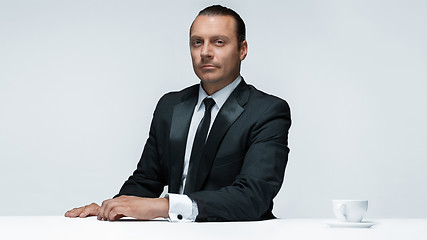 Image showing The attractive man in black suit on white background