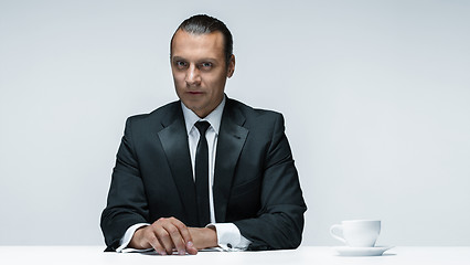 Image showing The attractive man in black suit on white background