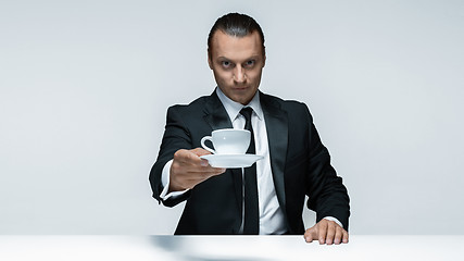 Image showing The attractive man in black suit on white background