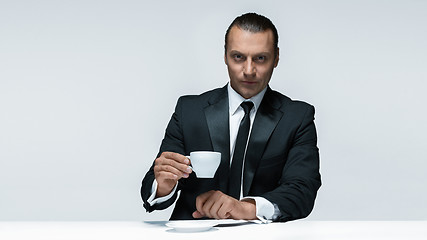 Image showing The attractive man in black suit on white background